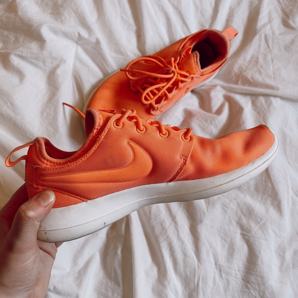 Bright coral/orange Nike tennies